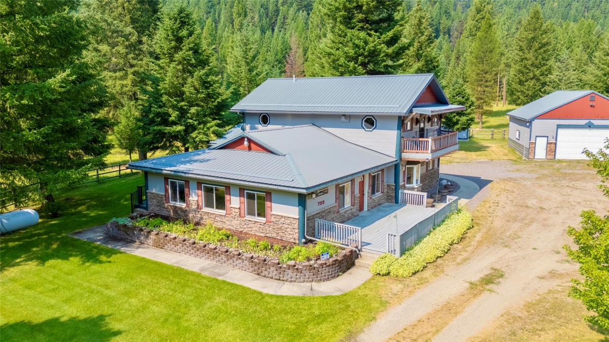 Two-story Missoula Valley home surrounded by evergreens